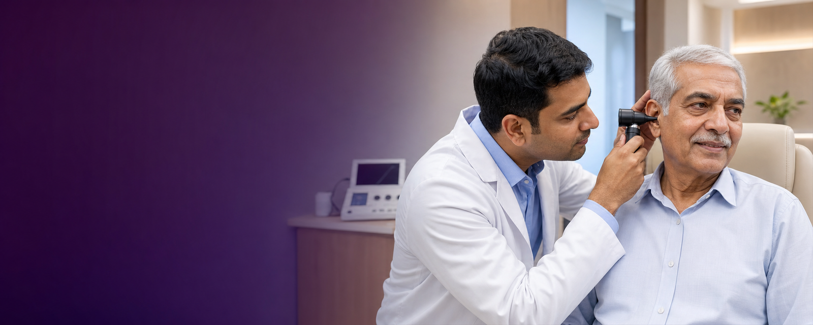 An audiologist gently checking an Indian senior man's hearing